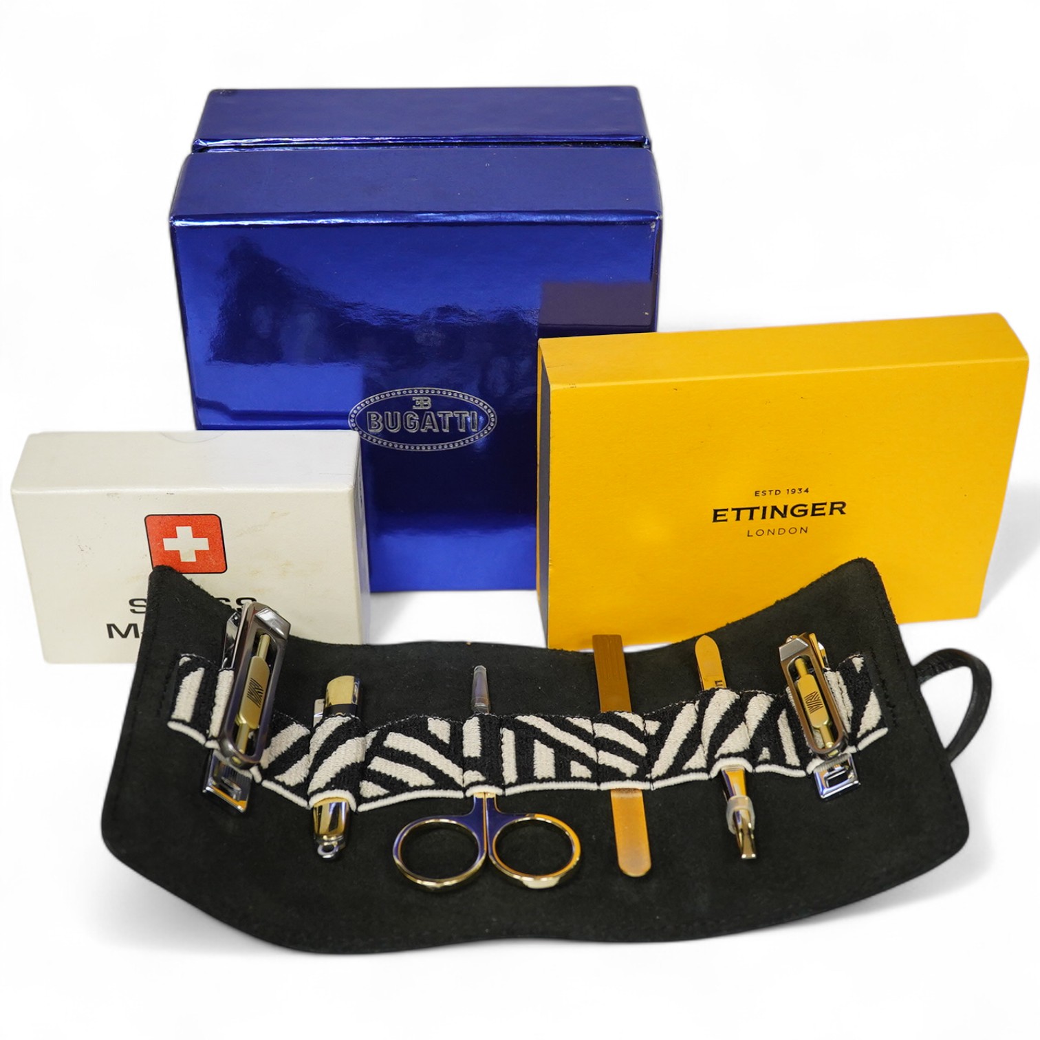 Sundry items comprising, two luxury wallets, boxed, Swiss military lighter and gent's manicure set. Condition - fair
